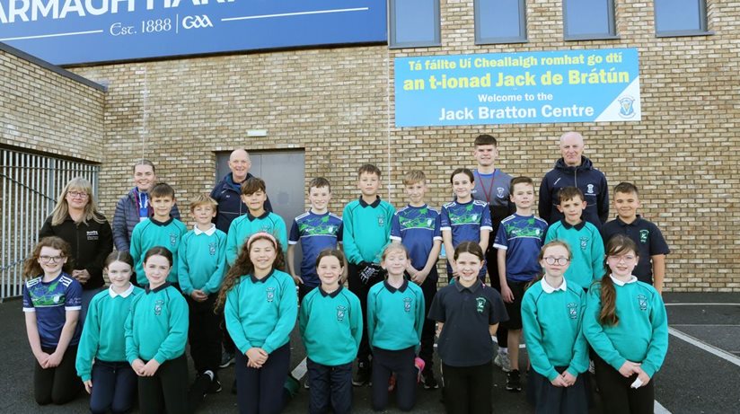 The Housing Executive’s Michelle Hazlett, teacher Eimear O'Kane and Declan Toal, Cathal Agnew and Brendan Powell from Harps GFC with children from St Patrick’s Primary School.