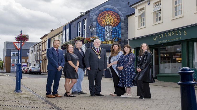 Housing Executive Chair Nicole Lappin (second from right) with her are (L-R); Causeway Area Manager Mark Alexander, Assistant Causeway Area Manager Noeleen Connolly, Council Officer: Prosperity & Place (Town & Village Management) Shaun Kennedy, Mayor of Causeway Coast and Glens Councillor Steven Callaghan, Consultant and Curator of Coleraine Revitalise Michelle McGarvey, and Department for Communities Officer Rhonda Williamson. 