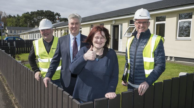 Delighted tenant Mechelle Davey, whose aluminium bungalow has been refurbished, shows her home to Brian Doran, Housing Executive Clerk of Works, Steven McBurney, Housing Executive team leader for Bangor, Ards and North Down Area, and Bosco Lyons, Hetheringtons. 