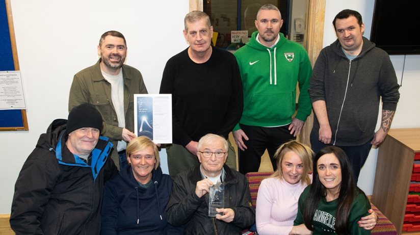 The Housing Executive’s good relations officer Stephen Gamble (back, left) congratulates chairperson Seamus Kelly (front, centre) and members of Bawnmore and District Residents Association on winning runner-up in the housing estates category of the all-Ireland IPB Pride of Place Awards 2022.