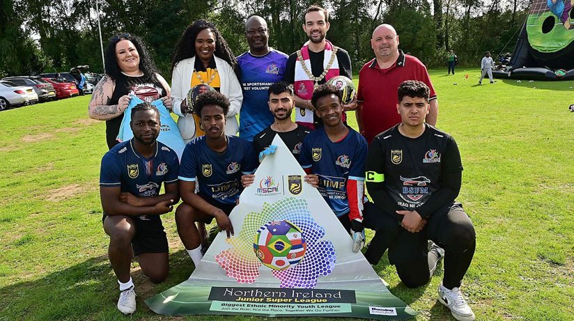 Lisa Hull, Housing Executive Good Relations Officer, Mayor of Derry and Strabane Lilian Seenoi-Barr, Jahswill Emmanuel BEM , Chairperson and Founder of  MSCNI, Belfast Lord Mayor Micky Murray, Anthony Clarke,  Race Relations Officer, Housing Executive, and players from the All Nation Junior Team, Somalia Junior Team and Iraq Junior Team. 