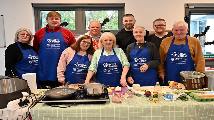 Residents learn new skills and knowledge about food at a healthy eating workshop. Pictured include Maire Scott, Lagmore Community Forum (front row, left), and Stuart Lavery, Housing Executive Good Relations Officer (back row, right).
