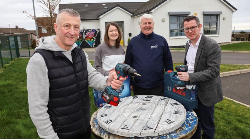 David Hunter, Hillside Men’s Shed, works on a clock face. Looking on are Jennifer Clements, from Newry Unite Community Centre, Kevin McGarry from M&M/Mascott and Niall Fitzpatrick, Housing Executive.