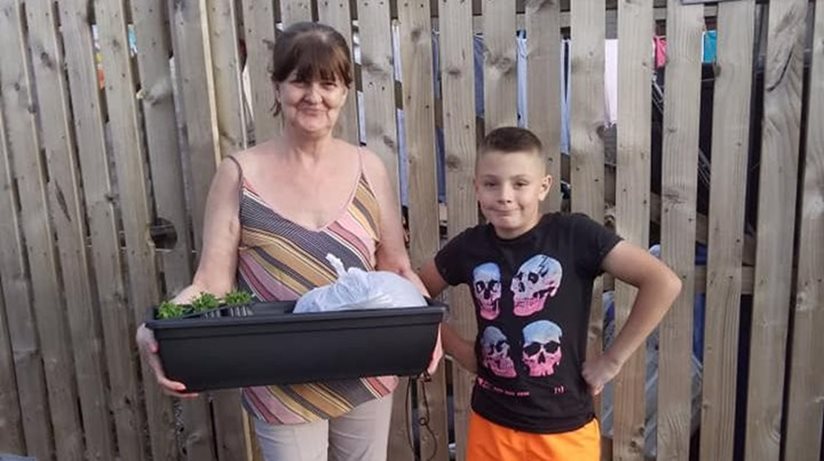 Dunvale residents receiving their window boxes as part of the Little Bit of Paradise Project, funded through the Housing Executive’s Covid-19 Response Fund and delivered by Dunclug youth Forum - Geraldine Ringland and her grandson