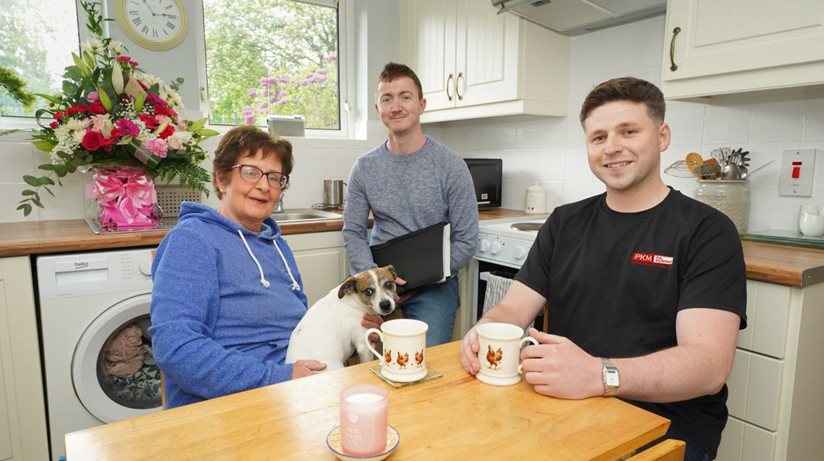 Tenant Catherine Brady shows off her new kitchen to Housing Executive patch manager Liam McKenna and Ciaran McDonald from PK Murphy, contractors.