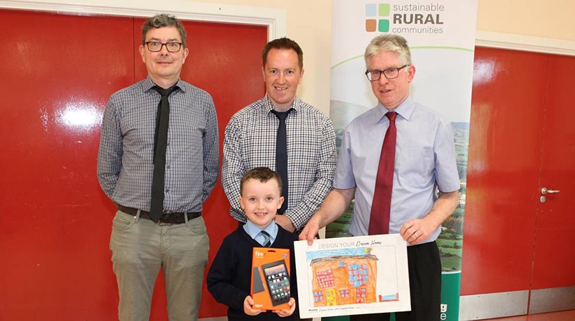 Our staff members Eoin McKinney (left) and John McAleavy (right) with school principal Ciaran Monaghan and winner Jonny who won a Kindle Fire.