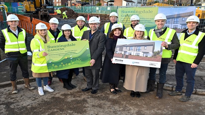 Caption: NIHE Chief Executive, Grainia Long, Chair of the Housing Executive Board, Nicole Lappin, Construction Director, GEDA Construction, Damian Murray and Department For Communities’ Director of Social Housing, Paul Price gathered with representatives from NIHE and GEDA Construction to cut sod on the new build pilot at Sunningdale Gardens, north Belfast.