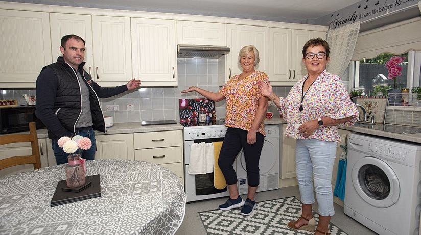 Home Improvements: Helen Kelly enjoys a cuppa in her new kitchen along with Housing Executive patch manager Martina McMahon and Eunan McCourt, PK Murphy. Her new kitchen was part of a £438,971 Housing Executive refurbishment scheme in towns across Fermanagh.