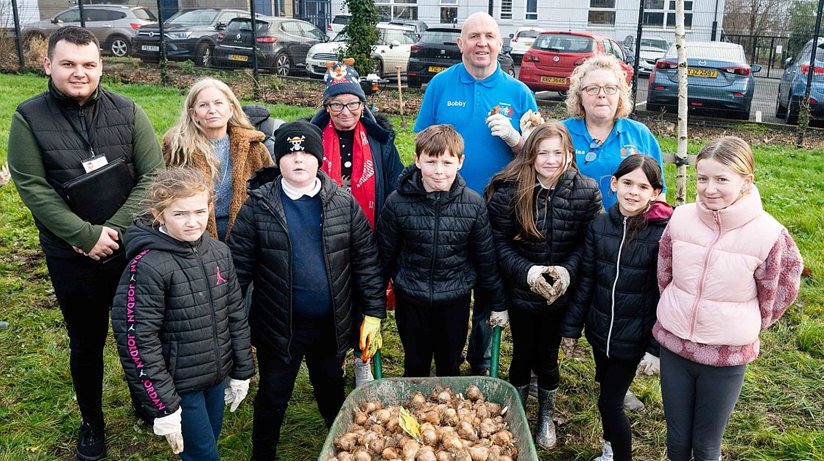 Spring is on its way at Silverstream…Pictured before planting daffodil bulbs with children from Silverstream Primary School are, Louis Richmond, Housing Executive Patch Manager, Mid and East Antrim, Lorraine Wilson, Housing Executive Team Leader, Carrick and Larne and Greenisland Community Council members, Maggie Watson, Lisa Morris and Bobby Hadden.