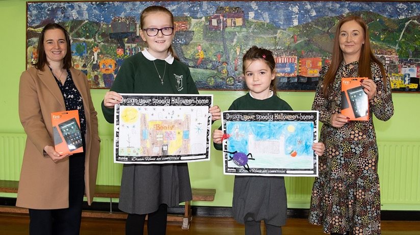 Pictured from L-R are Breena Hasson (Triangle Housing),  St Patrick Primary School pupils Aideen McTagne and Aoife McCann, and Lynsey O’Neill (Housing Executive patch manager).  The pupils each won computer tablets in the Housing Executive Dream Home Design competition.