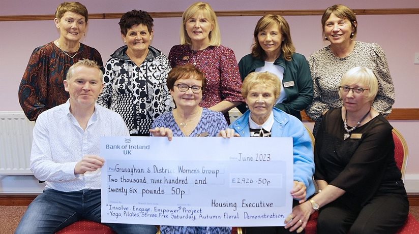 Pictured (front row) left to right: The Housing Executive’s PJ Ward with Chairperson Deirdre Bradley and group members.