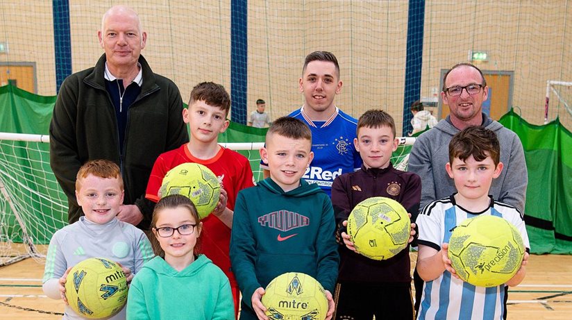 Teamwork across the divide: Pictured with young footballers at the D3Mac cross-community football sessions held at Ballymena North Business Centre and supported by the Housing Executive Cohesion grant are, (from left to right), John Read, Housing Executive’s Good Relations Officer, Mid and East Antrim, Adam Gordon, football coach and Peter Havelin, D3Mac Community Worker.