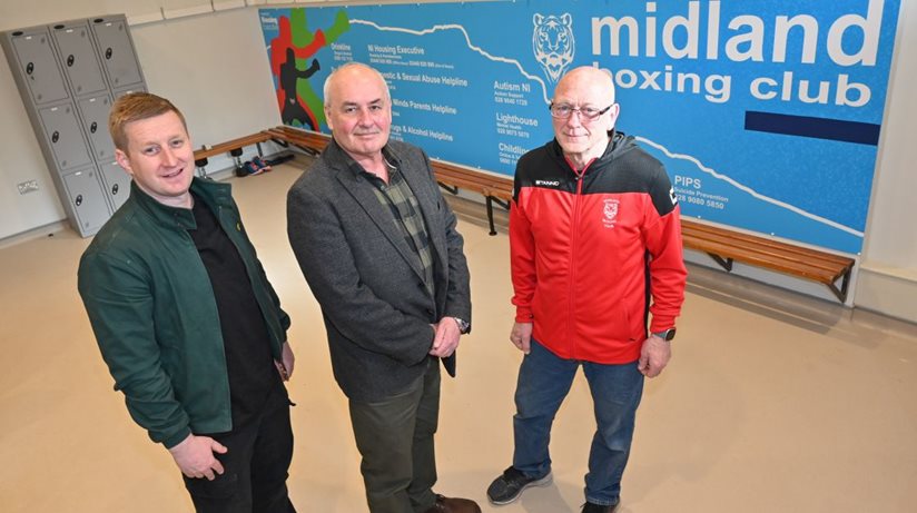 David McErlean, Patch Manager, and Dr Sean Brennan, Good Relations Officer, Housing Executive, are shown a new mural displaying helplines by Sam Cochrane at Midland Boxing Club in north Belfast.