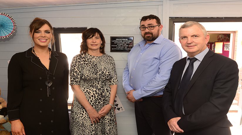 (L-r) Rioghnach Murphy, Shared Services Manager at Glen Alva & Grosvenor Centres poses with Supporting  People’s Bernie Crossan, The Salvation Army’s Assistant Regional Manager, Steven Potter and the Housing Executive’s Des Marley, beside a plaque marking the opening of the Support Activities Hub.