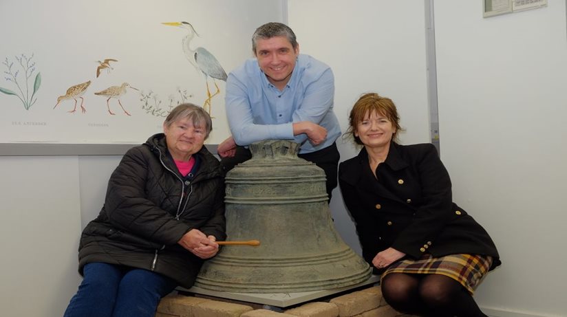 Gareth Morgan, from the Housing Executive, hands over the Shrigley Bell for safe keeping to Dr Elizabeth Crilly (right), from the Sir Hans Sloane Centre in Killyleagh. Belle Russell was also there representing the residents of Shrigley village.