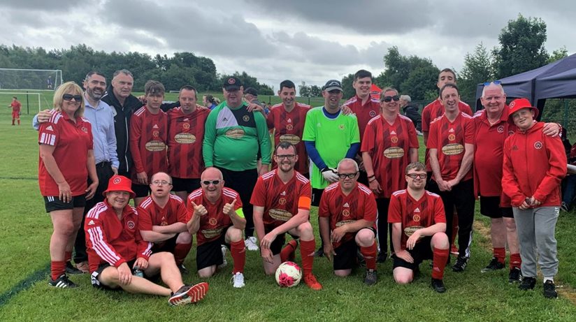 We are the Champions: celebrating with the winners of the George Best Community Cup 2023 are Housing Executive’s South Antrim Good Relations Officer Stephen Gamble and Joint Managing Directors of Bridge Association in Antrim, Jacqueline Barnes (far left, back row) and David Edmont (second from the right, back row)