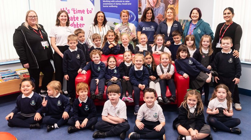 Pictured with Acorn Integrated Primary School P2 pupils and teachers are Emily Holt, Housing Executive Learning and Organisation Development Support Officer, Michelle Larkin, Housing Executive Damp and Mould Project Manager, Kellyanne Davoll, Housing Executive Learning and Development Business Partner and Ciara Mulgrew, Programme Manager, Business in Community for Primary Schools.