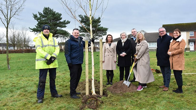 Grainia Long, Chief Executive, Housing Executive (with spade), at the tree-planting ceremony in Carnhill Estate. Included from left: Mark Hunter, Housing Executive Grounds Superintendent, Liam Lynch, Housing Executive Grounds Supervisor, Martina Forrest, Team Leader, Collon Terrace Housing Executive, Sharon McCullagh, DfC, Darren Kirby, Strategy Manager for Neighbourhood Renewal Partnership, Eddie Doherty, West Area Manager and Deirdre Rafferty, Housing Executive Neighbourhood Officer.