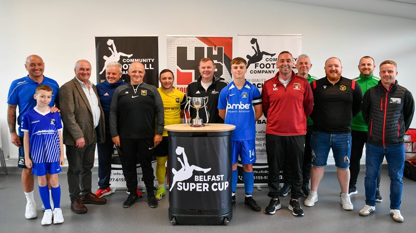 Housing Executive Good Relations Officer Dr Sean Brennan with some of the players and organisers of the Belfast Super Cup which involved 300 local youths.