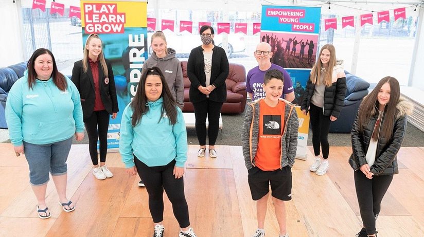 Pictured in the new outdoor marquee part funded by the Housing Executive are members of the Monkstown Boxing Club “This Girl Can” young women’s group, along with Paul Johnston, Monkstown Boxing Club project manager and Bronagh Spackman, Housing Executive Good Relations Officer.