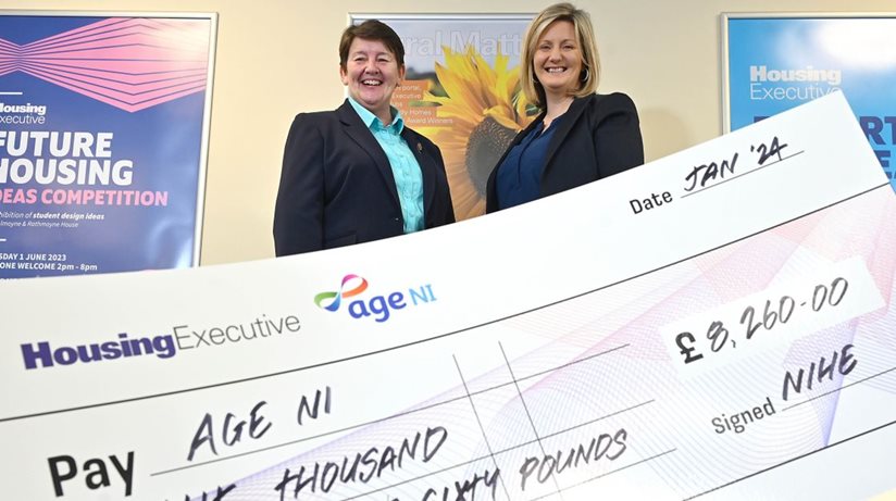Linda Robinson Age NI Chief Executive receives the cheque from Housing Executive Chief Executive Grainia Long