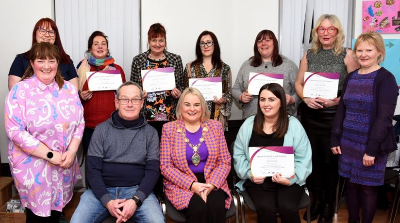 Standing left-to-right is course facilitator Cathy Malcolm from CM Consultancy, Health Hub's Anne Marie Campbell, Emer McCallion, Cathy McLaughlin, Samantha Higgins, Amanda Boyd, Shirley McClean, and Housing Executive team leader Norma Buchanan. Seated left-to-right: Housing Executive Good Relations Officer Eddie Breslin, Mayor of Derry City and Strabane District Council Cllr Sandra Duffy and Ena Gormley from the Waterside Women’s Centre