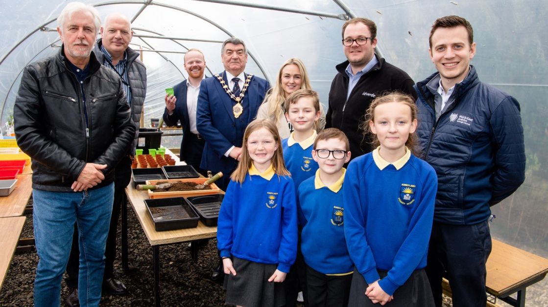Mayor Noel Williams in the polytunnel with Sunnylands Primary School in the Sunnylands Primary School allotments in Carrickfergus, with staff from the Housing Executive and Idverde, and local elected representatives.