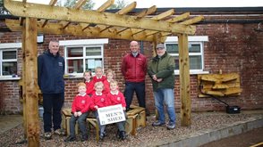 Housing Executive Good Relations Officer Gerard Smith with school Principal John Anderson, Karl Stafford from Men’s Shed Ballynahinch and Primary One pupils.