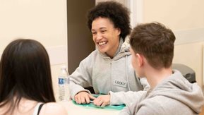 Lucky chats with two other young people at the Café event in Glengormley.