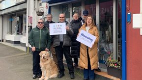 Six people with Rural Community awards signs 