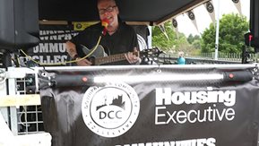 A man plays guitar on stage.