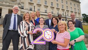 NIHE staff, politicians and representatives of other stakeholder bodies appear outside Parliament Buildings, Stormont.