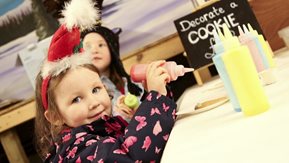 Two children are pictured at a Christmas Grotto.