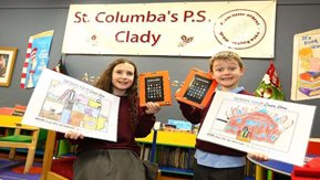 Two children pose with their prizes