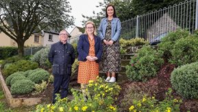 3 people in a garden