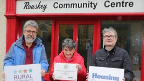 Kevin Moquin and Bridie McCullagh 5receive their award from Eoin McKinney outside the Rouskey Community Centre.