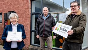 Three people hold boards