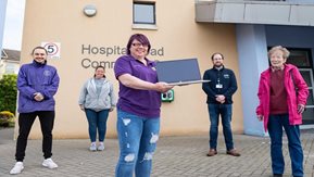 five people stand outdoors outside the Hospital Road community centre