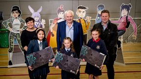 Three school children pose with prizes