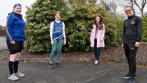 Four people pose for camera 