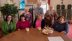 A group of people having a cup of tea together