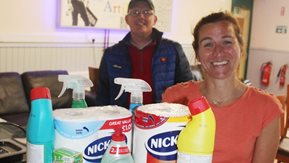 A woman and man with grocery items.