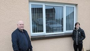 Man and a woman stand beside new window