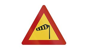 A warning sign indicates strong winds.