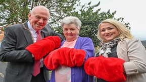 Three people posing with handwarmers