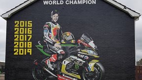 Mural of Jonathan Rea on the side of house.