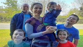 A family of six smile in a group photo 