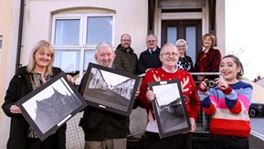 A number of Gallows Hill residents display their photographs, accompanied by the Housing Executive's Christopher Spence.
