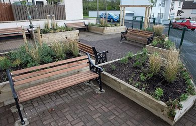 Foreglen's new community garden with garden benches.